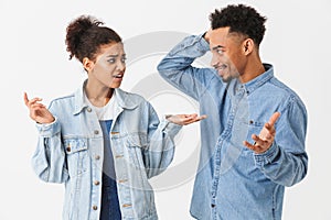 Pretty african couple in denim shirts quarrels between themselves