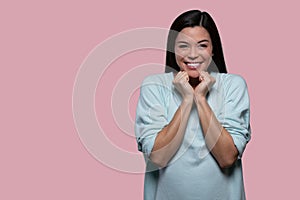 Pretty asian american woman overjoyed and excited portrait, isolated on pink background