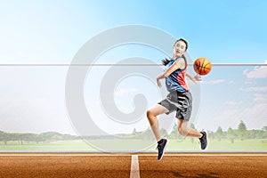 Pretty asian basketball player woman with ball in action