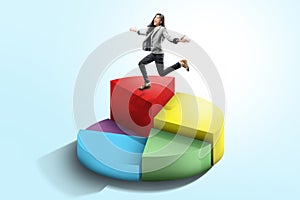 Pretty asian business woman running on the 3d pie chart