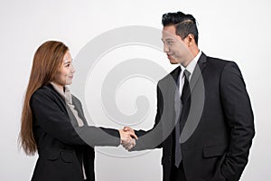 Pretty Asian businesswoman shaking hands businessman to seal a deal with his partner on a white background