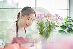 Pretty Asian Female florist working in flower shop