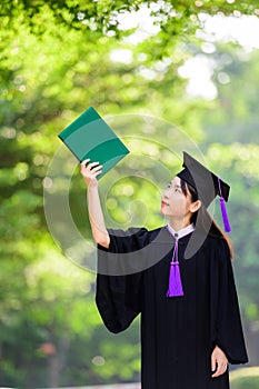 Pretty asian female holding diplomas