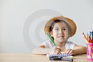 A pretty asian girl drawing, writing