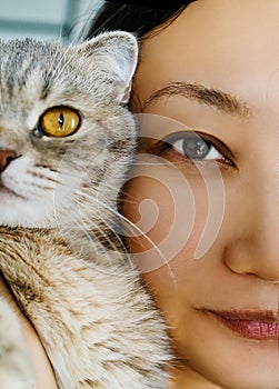 Pretty Asian Girl Holding Little Kitty Cat Near Face