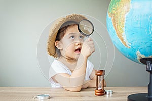 A pretty asian girl using magnifying glass