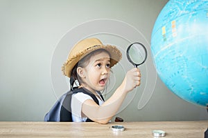 A pretty asian girl using magnifying glass