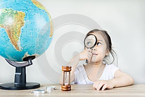 A pretty asian girl using magnifying glass