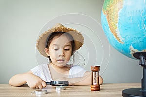 A pretty asian girl using magnifying glass