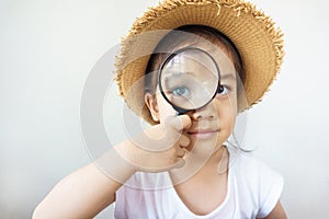A pretty asian girl using magnifying glass