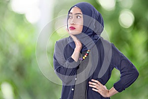 Pretty asian muslim woman with headscarf and hand on face