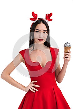pretty asian woman in deer costume holding ice cream cone with christmas ball