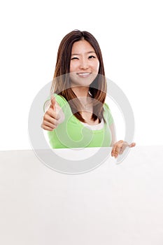 Pretty asian woman holding a penel and show thumb