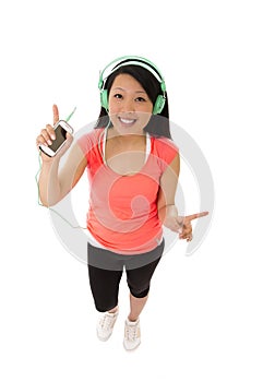 Pretty asian woman listening to music headphones