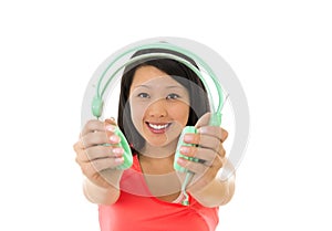 Pretty asian woman listening to music headphones