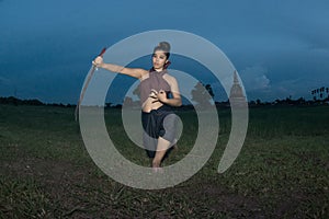 Pretty Asian woman posing in Thai ancient warriors dresses.