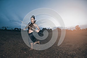 Pretty Asian woman posing in Thai ancient warriors dresses.