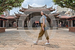 Pretty asian woman taking a tour of the temple.