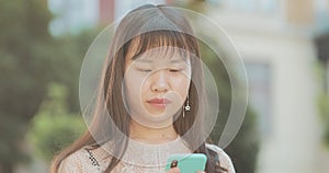 Pretty asian woman using mobilephone.