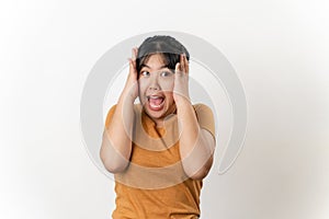 The pretty Asian young woman with surprise and shocked facial expression standing on a white background
