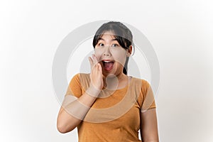 The pretty Asian young woman with surprise and shocked facial expression standing on a white background