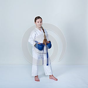 Pretty athlete with a blue belt and blue overlays on her arms