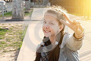 pretty attractive young girl shows victory sign \