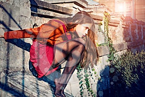 Pretty Autumn woman in skirt and stockings sit stairs architecture background. Fashion concept. Youth fashion. Enjoy