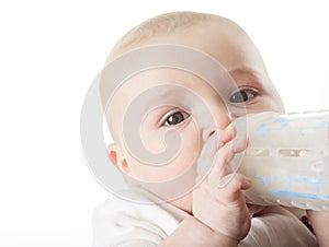 Pretty baby boy drinking milk from bottle