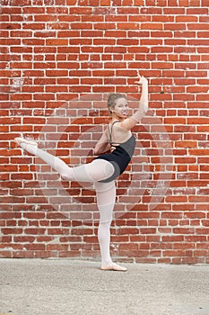 Pretty ballet girl and red masonary.