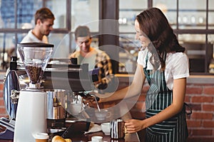 Pretty barista making a cup of coffee