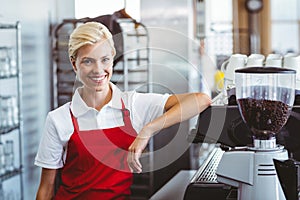 Pretty barista smiling at the camera