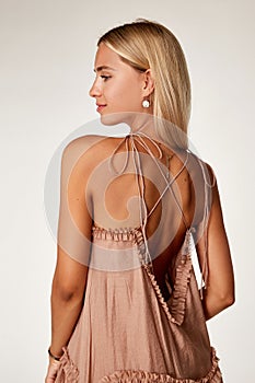 Pretty beautiful sexy elegance woman skin tan body fashion model glamor pose wear  long beige silk trend dress party summer