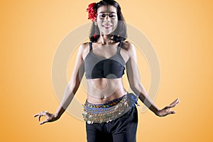 Pretty belly dancer doing dance exercises on studio