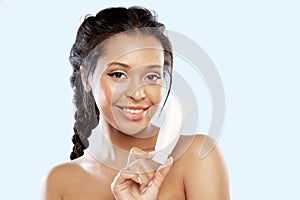 Pretty black girl holding mock-up tube with cream