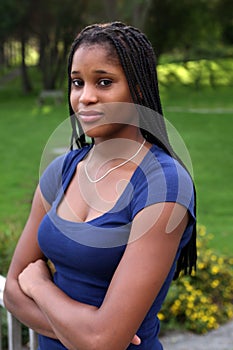 Pretty black teenage girl in a green park