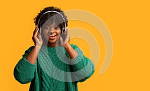 Pretty black woman in wireless headset listening to music