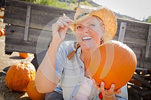 Pretty Blond Female Rancher Wearing Cowboy Hat Hol