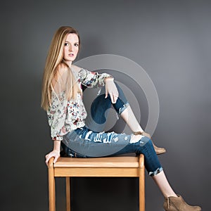 Pretty blond girl against a grey background