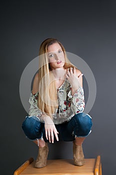 Pretty blond girl against a grey background