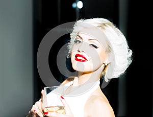 Pretty blond girl model like Marilyn Monroe in red lips. Sensual smiling sexy retro woman.