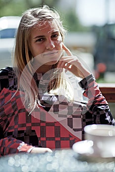 Pretty blond girl sitting in a cafe