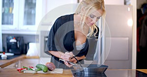 Pretty blond woman making the dinner