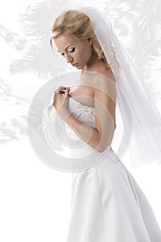 Pretty blonde bride with hand on the breast