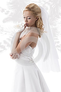 Pretty blonde bride looks down at left