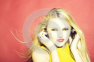 Pretty blonde dg girl in headset on pink