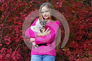 Pretty blonde girl with chihuahua on the nature