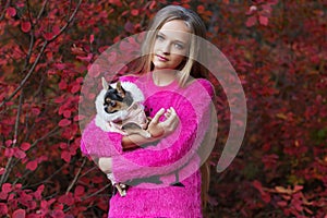 Pretty blonde girl with chihuahua on the nature