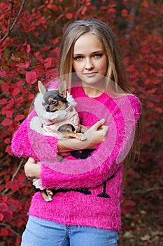 Pretty blonde girl with chihuahua on the nature