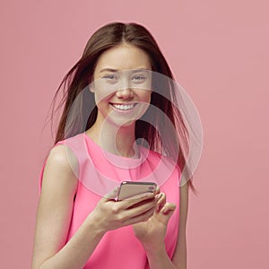 Pretty blonde girl pays for online purchases in a mobile phone, after adding a card to the app. Payment by credit card.